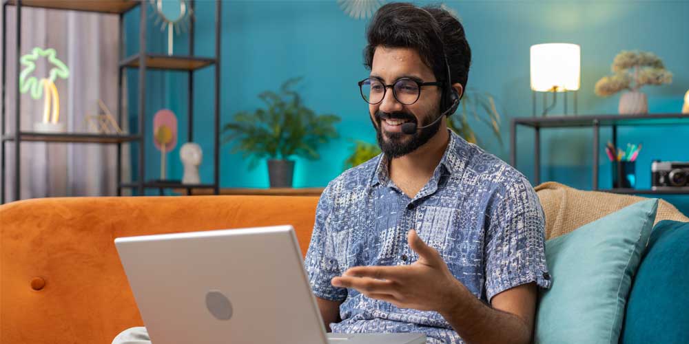 IT professional accessing virtual desktop infrastructure on a laptop in an Indian enterprise office